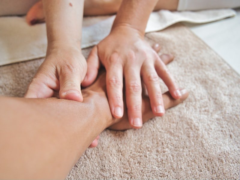 Hands resting gently during a calm reflexology session